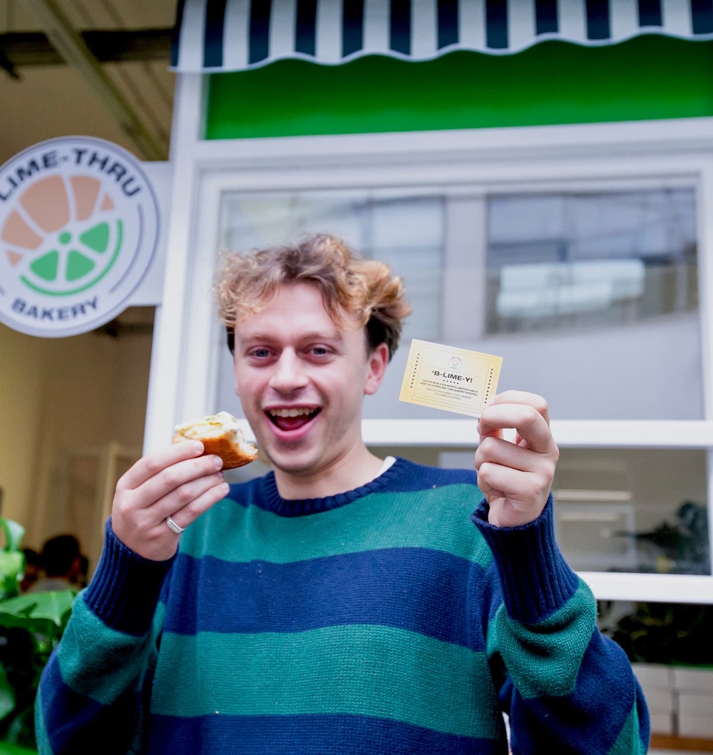 A customer shows off a cronut and a 'B-Lime-Y!' golden ticket from the Lime-Thru Bakery pop-up